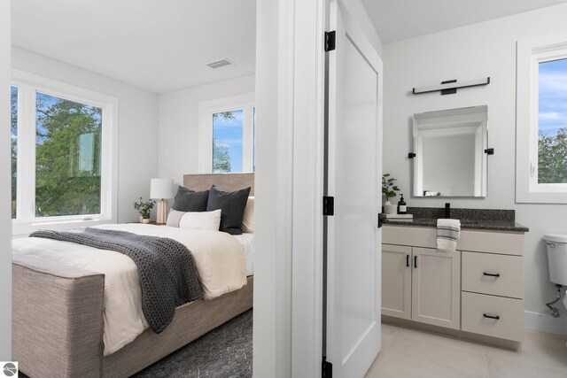 bedroom with light tile patterned floors