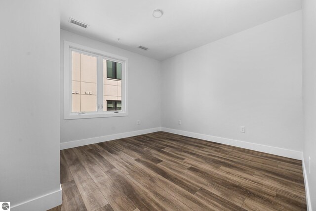 empty room with wood-type flooring