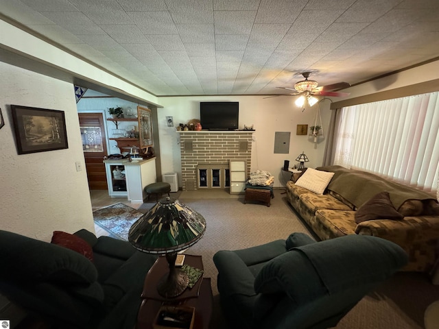 living room with ceiling fan, electric panel, carpet floors, and a brick fireplace