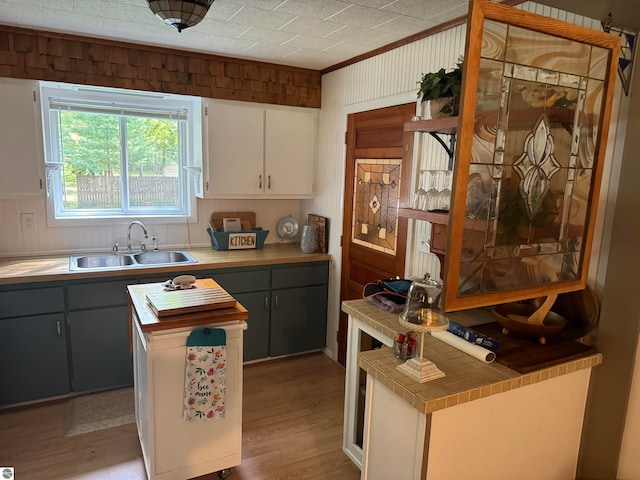 kitchen featuring gray cabinetry, sink, light hardwood / wood-style flooring, and white cabinets