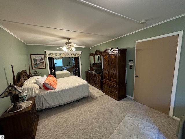 carpeted bedroom featuring ornamental molding and ceiling fan