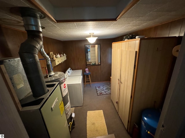 basement with carpet, gas water heater, wood walls, and washing machine and clothes dryer