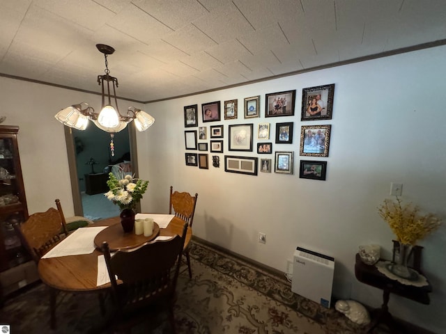 dining room featuring a notable chandelier and crown molding