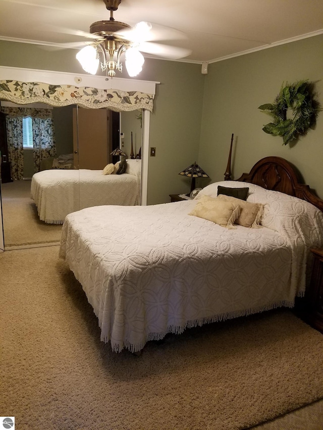 bedroom featuring ornamental molding, ceiling fan, and carpet floors