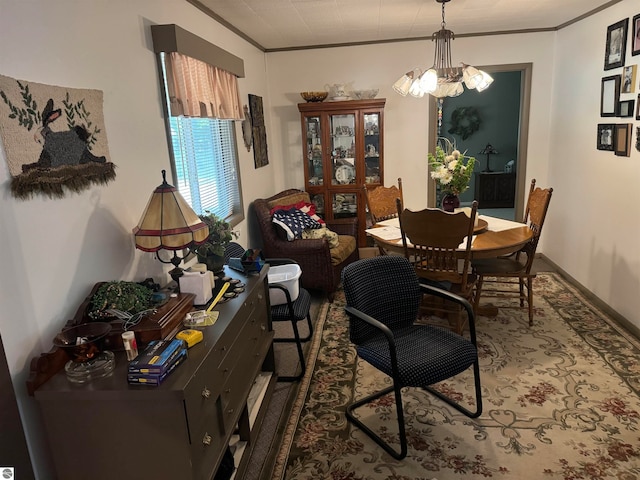 dining space with crown molding and a notable chandelier