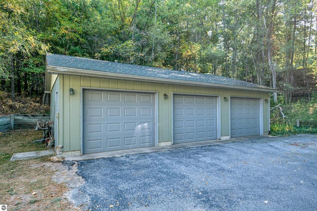 garage featuring wood walls