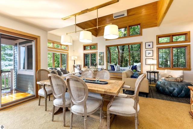 dining area featuring light carpet, plenty of natural light, and a wall unit AC