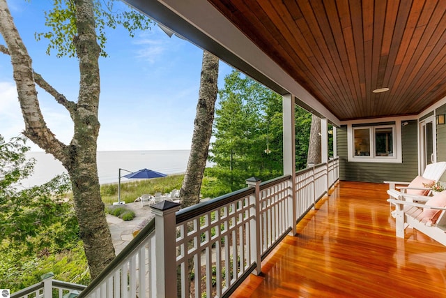 wooden deck featuring a water view