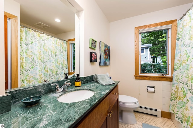 bathroom with vanity, baseboard heating, tile patterned flooring, and toilet