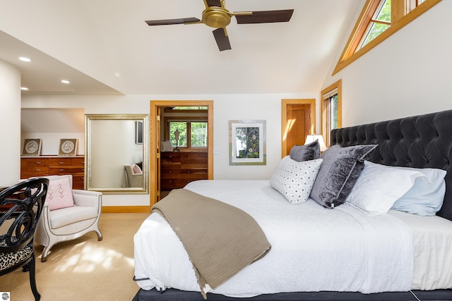 bedroom with lofted ceiling, ceiling fan, and light colored carpet