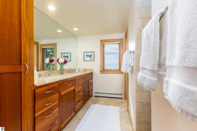 bathroom featuring vanity, baseboard heating, and tile patterned floors