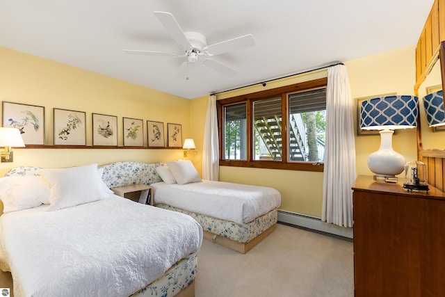 bedroom with ceiling fan, light colored carpet, and a baseboard radiator