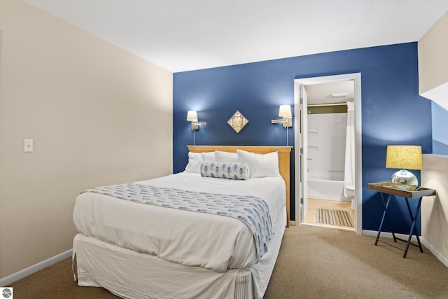 bedroom featuring connected bathroom and carpet flooring