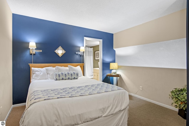 bedroom featuring a textured ceiling, carpet flooring, and ensuite bathroom