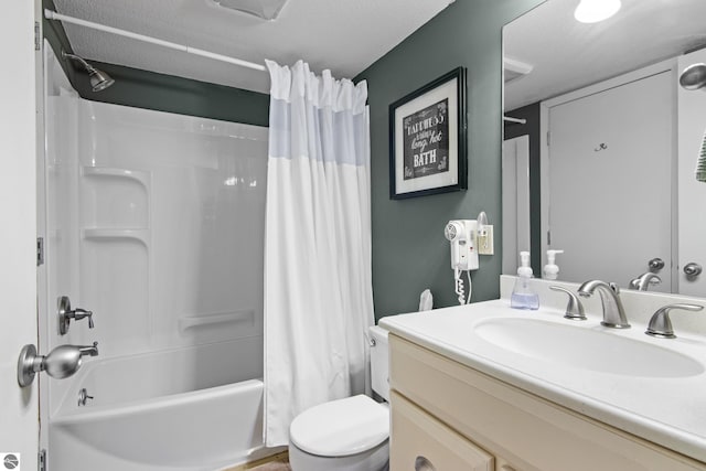 full bathroom with a textured ceiling, shower / tub combo with curtain, vanity, and toilet