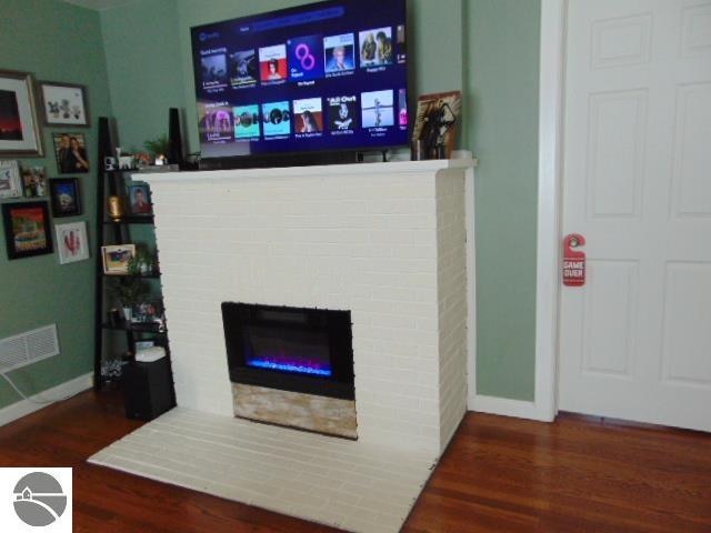 interior space with wood-type flooring and a fireplace