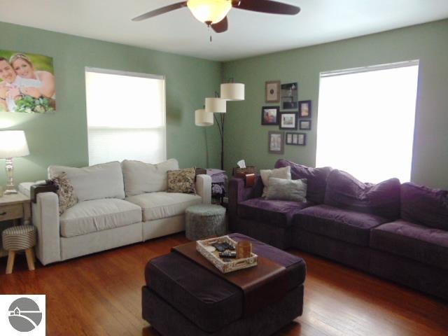 living room with hardwood / wood-style flooring, ceiling fan, and plenty of natural light