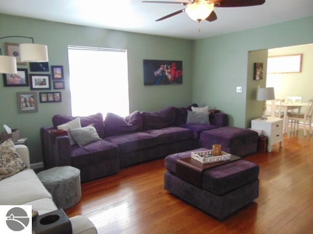 living room with ceiling fan and wood-type flooring