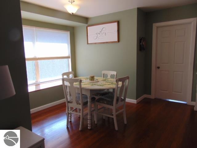 dining space with dark wood-type flooring