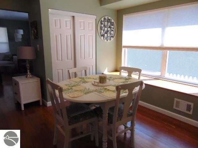 dining room with dark hardwood / wood-style floors