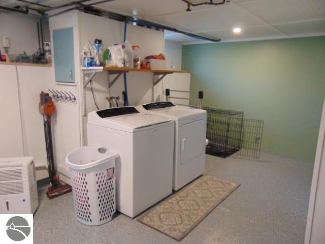 clothes washing area featuring washing machine and clothes dryer