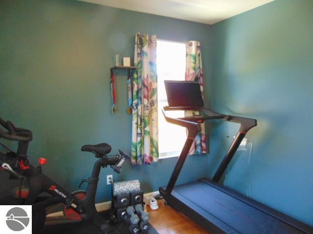 exercise room with wood-type flooring