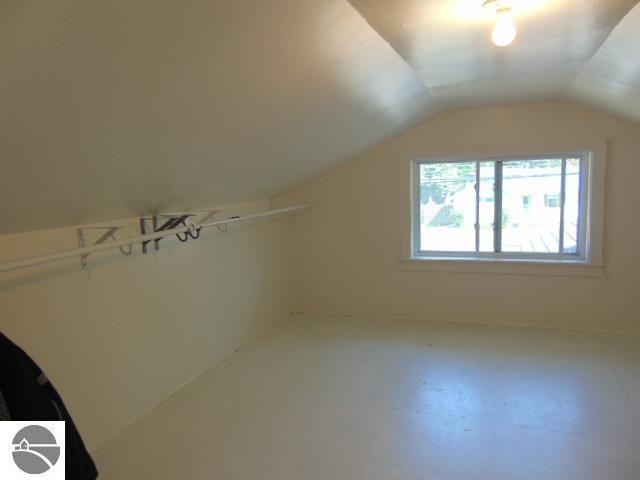 additional living space with vaulted ceiling