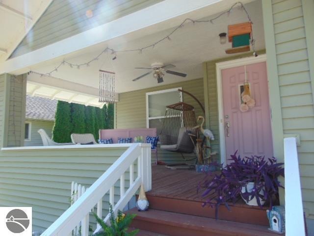 entrance to property featuring ceiling fan