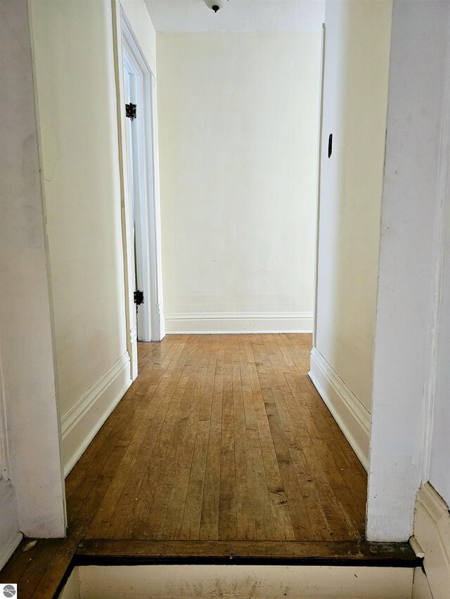 living room with light wood-type flooring, crown molding, and a wood stove