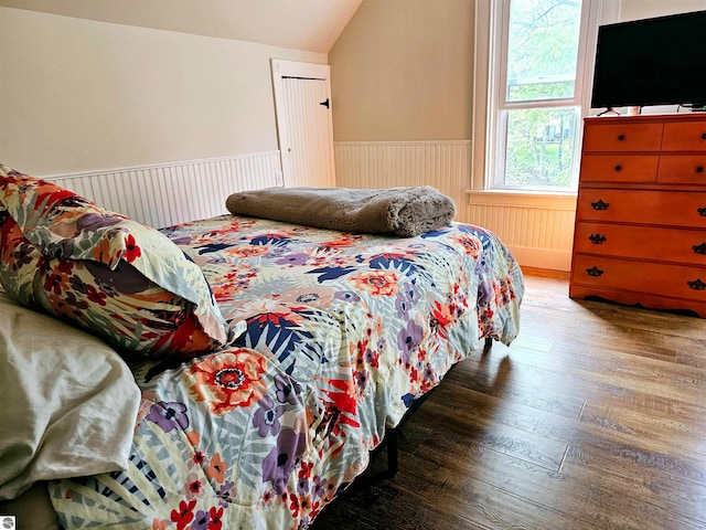 bedroom with light wood-type flooring and lofted ceiling