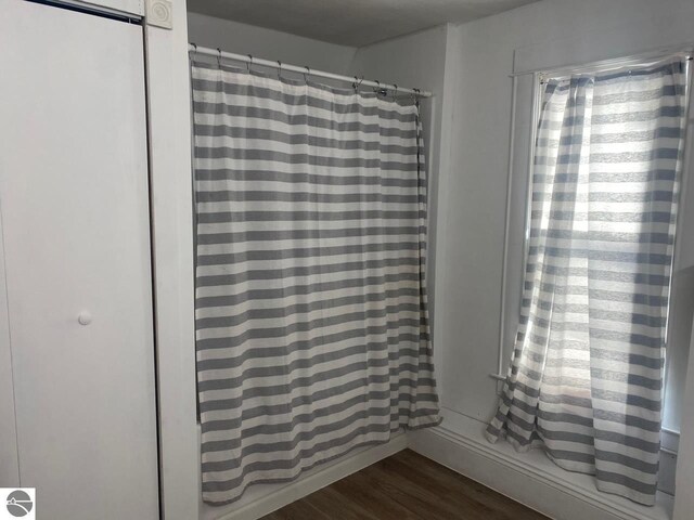 bedroom with light wood-type flooring, a closet, and a walk in closet