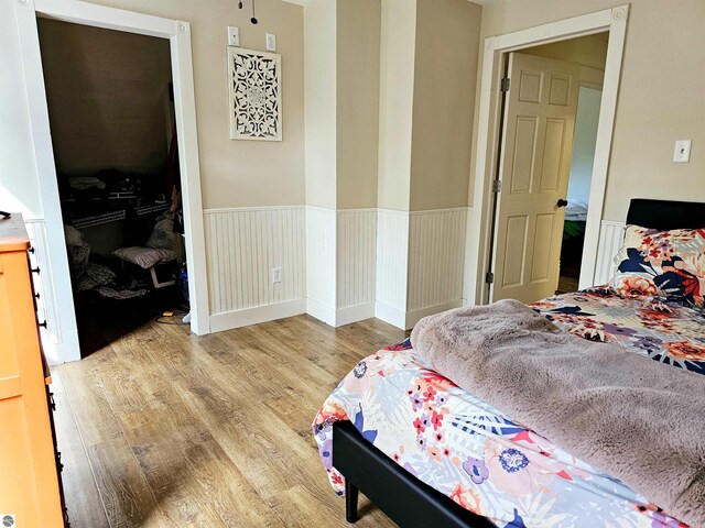 bedroom with wood-type flooring and lofted ceiling