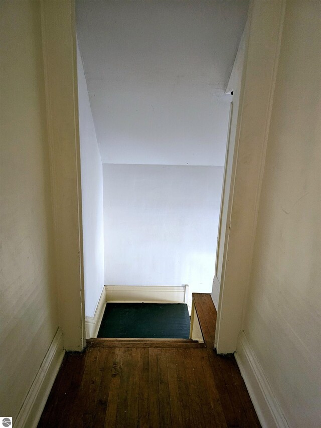 corridor with dark wood-type flooring