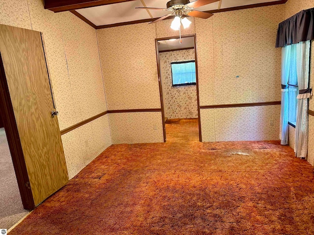 carpeted spare room featuring vaulted ceiling with beams and ceiling fan