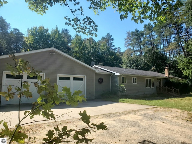 single story home with a front yard and a garage