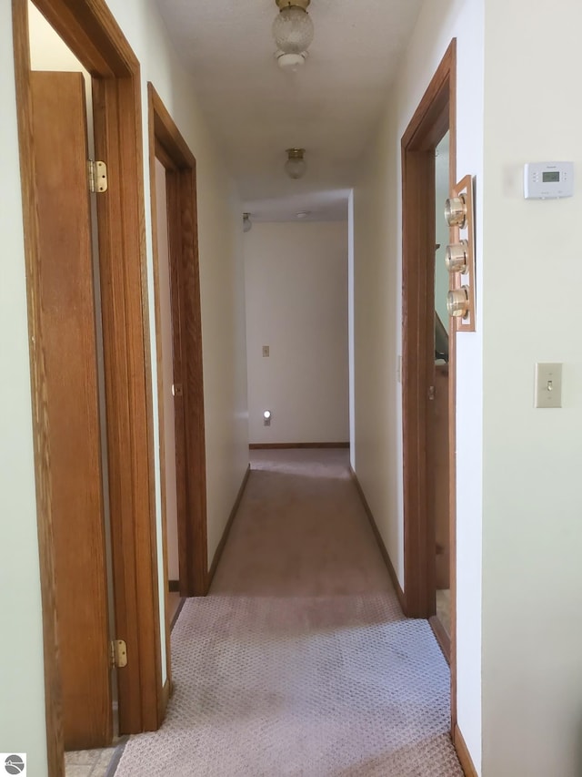 hallway with light colored carpet