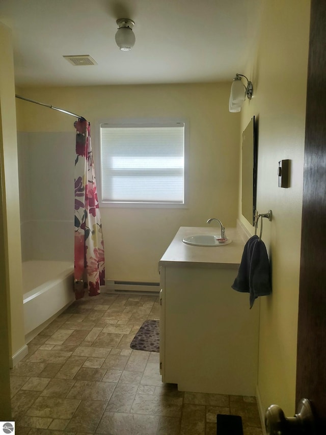 bathroom featuring vanity, a baseboard radiator, and shower / tub combo