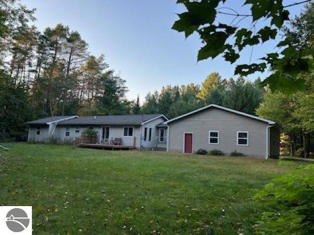 rear view of house featuring a yard