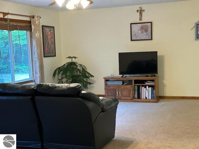 living room with ceiling fan and carpet