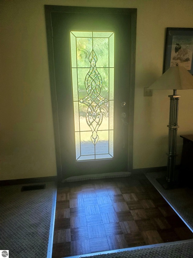 entryway with parquet flooring