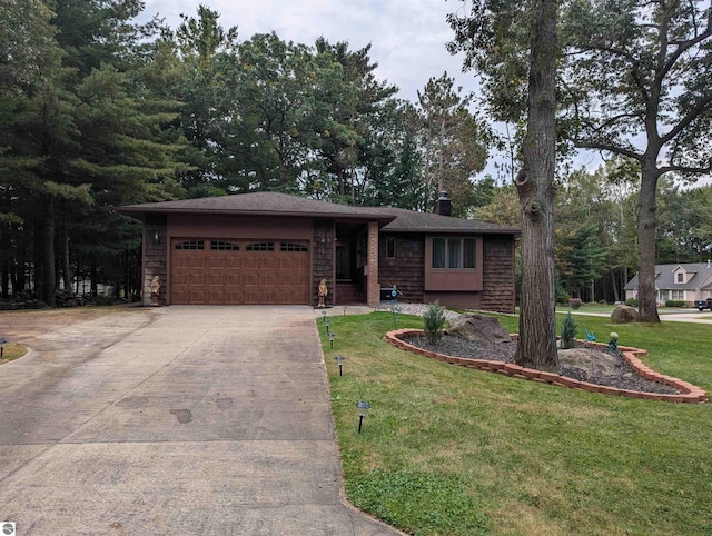 view of front of property with a front yard and a garage