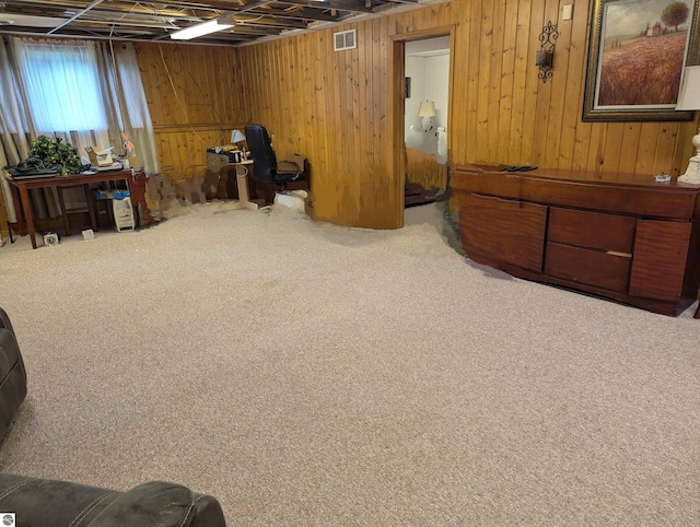 misc room featuring wooden walls and carpet