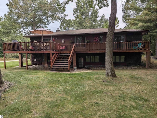 rear view of property with a lawn and a wooden deck