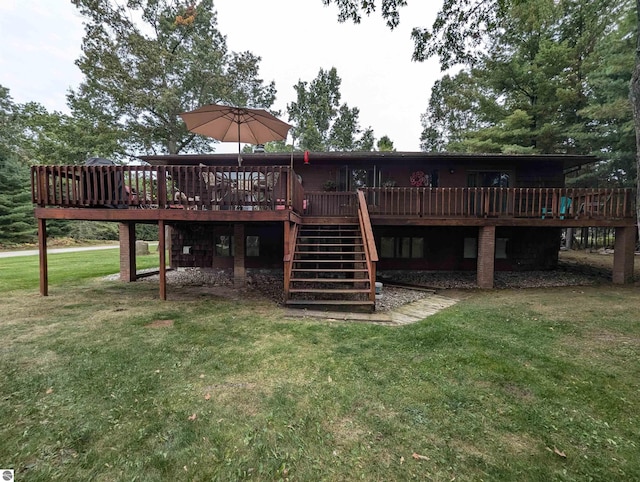 back of property with a deck and a lawn