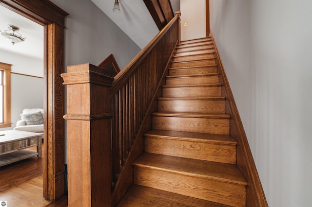 stairs featuring hardwood / wood-style flooring