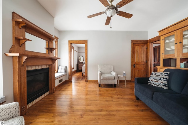 living room featuring ceiling fan and hardwood / wood-style flooring