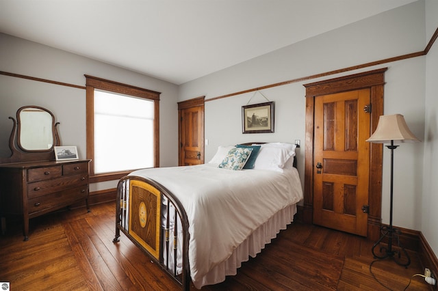 bedroom with dark hardwood / wood-style flooring