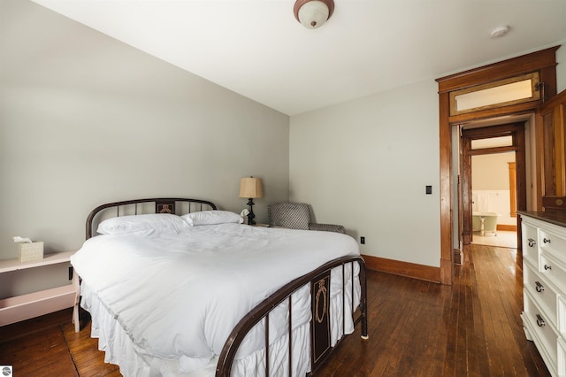 bedroom with dark hardwood / wood-style flooring