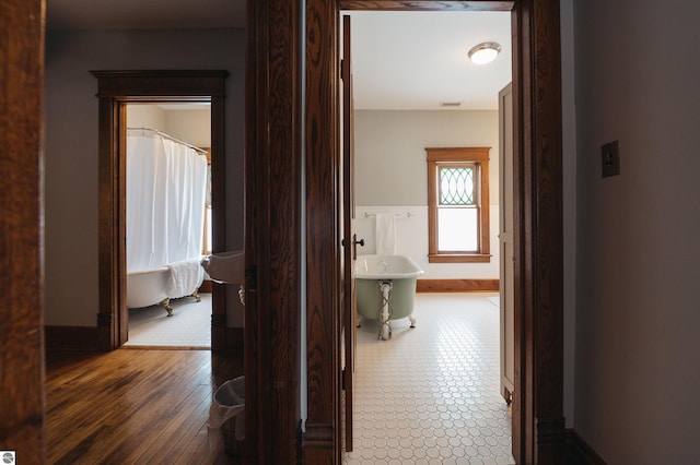 corridor featuring dark hardwood / wood-style flooring