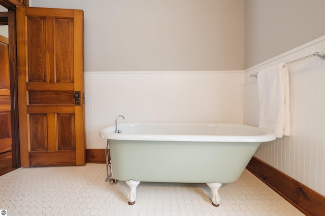 bathroom with wooden walls and a bathtub